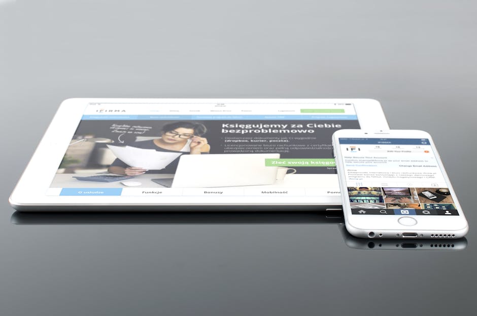 Modern tablet and smartphone displaying web content on a reflective surface, highlighting technology and connectivity